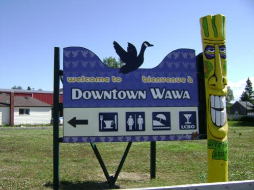 8' x 6' Directional Sign for Town.  CMY Print.  Yellow Gitchee Goomee, (totem) made by local artist.  www.gitcheegomme.com