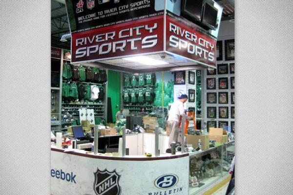 We fabricated a custom sales counter to look like rink boards c/w plexi tops and created a faux score clock to hang above.

Visit www.xtremesign.ca
