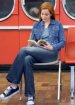 Pretty redhead in denim jacket and jeans reading a book.jpg