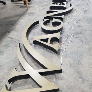 trimless edge channel letters with painted gold perf vinyl