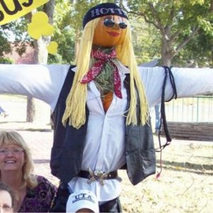 pumpkin scarecrow with pumpkin head and cleavage