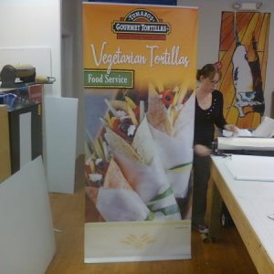 1 of the 6 36"x84" trade show displays for Blue Marble Brands next to the shop's secretary Brandy for size relation.