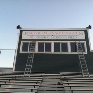 this sign is a framed aluminum 24' long. it was assembled on the roof and installed with BIG screws