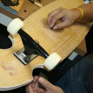 Engraved wood skateboard 6
Put the wheels on to see if we put the screw holes in the right place.