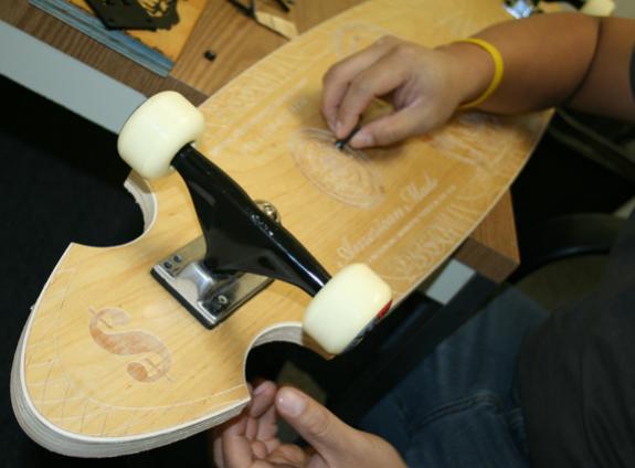 Engraved wood skateboard 6
Put the wheels on to see if we put the screw holes in the right place.