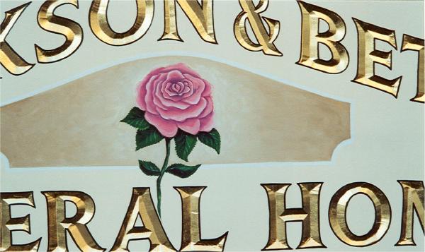 hand painted rose on carved sign