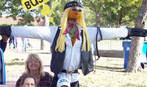 pumpkin scarecrow with pumpkin head and cleavage