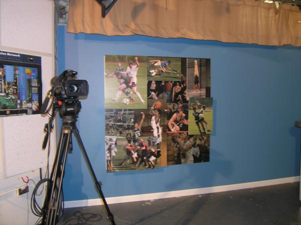 The backdrop for the local high-school's weekly television show's sports desk. Assorted prints mounted to coroplast and attached to a board at differe