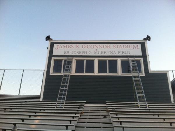 this sign is a framed aluminum 24' long. it was assembled on the roof and installed with BIG screws